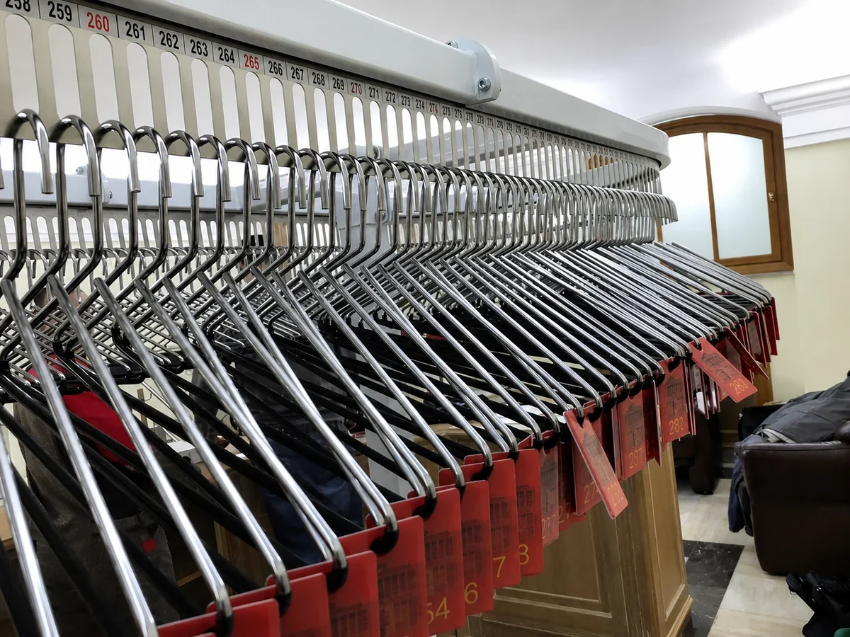 automated cloakroom planning: Numbered coat check conveyor positions for organized guest garment storage