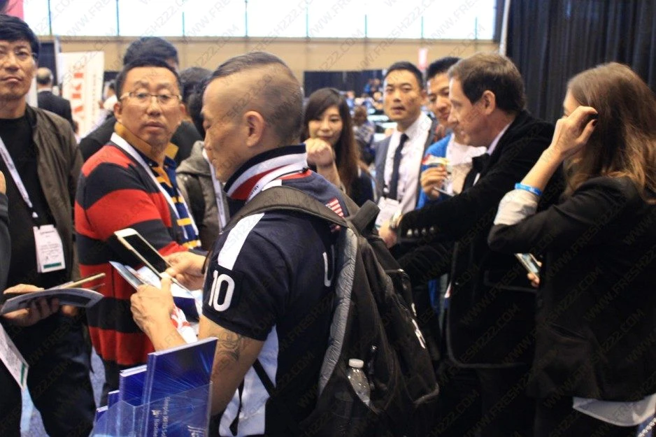 Trade-show visitors discussing automation systems